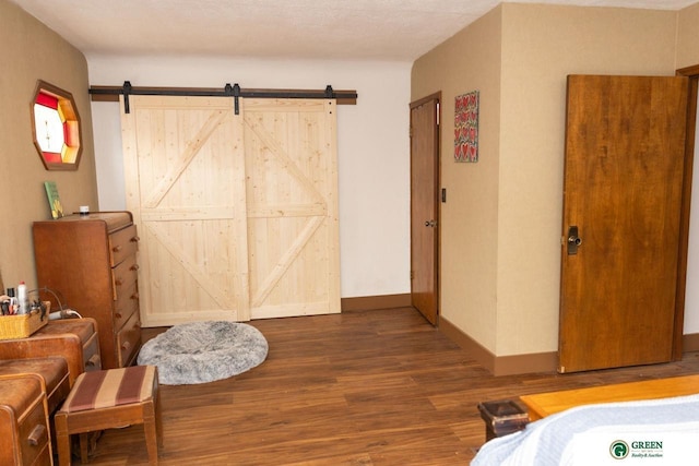 650 E 9th St, York, NE 68467 - bedroom with a barn door, wood finished floors, and baseboards