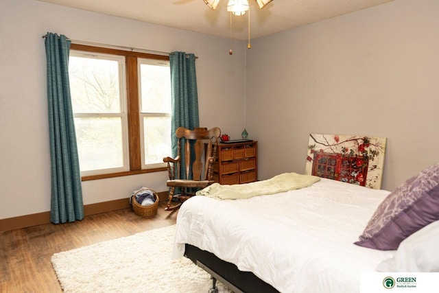 650 E 9th St, York, NE 68467 - bedroom with multiple windows, wood finished floors, and baseboards