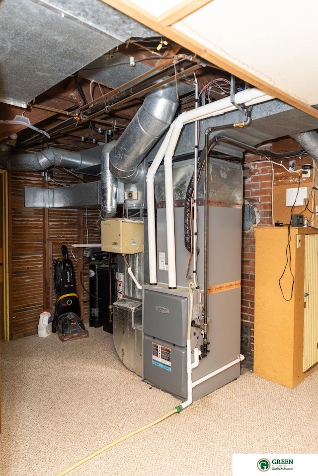 650 E 9th St, York, NE 68467 - unfinished below grade area with heating unit and carpet flooring