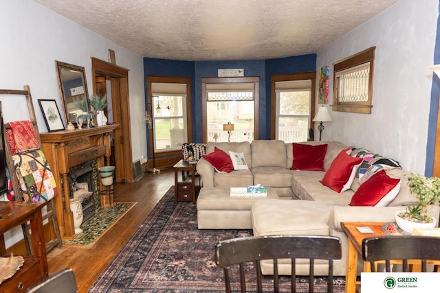 650 E 9th St, York, NE 68467 - living area featuring wood finished floors, a textured ceiling, and a fireplace with flush hearth