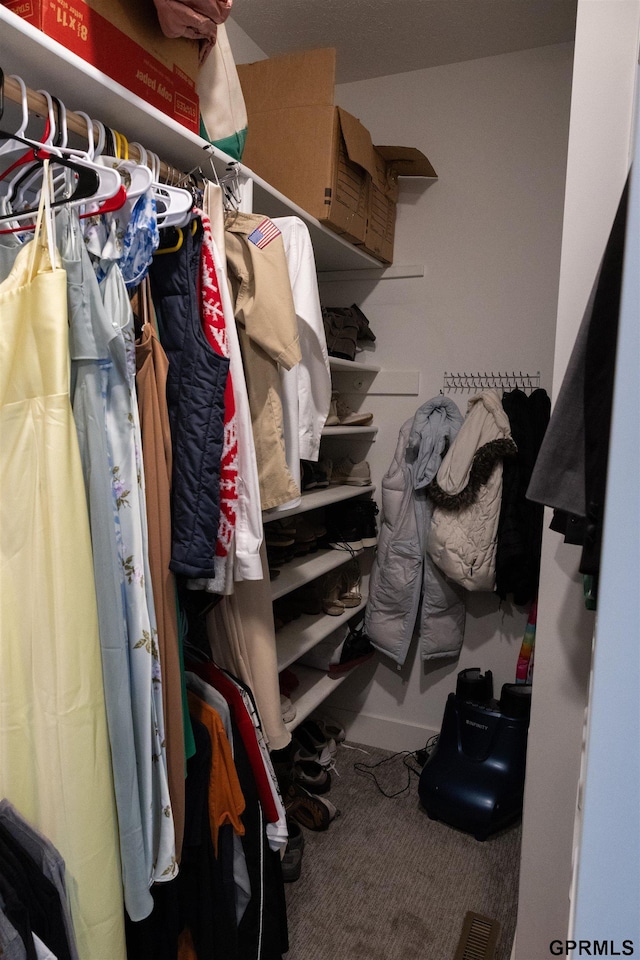 walk in closet with visible vents and carpet floors