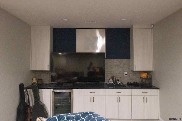 kitchen featuring decorative backsplash, white cabinets, recessed lighting, and beverage cooler
