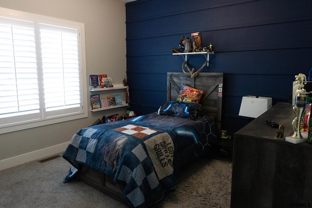 carpeted bedroom featuring baseboards