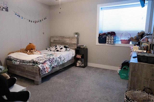 bedroom featuring carpet and baseboards
