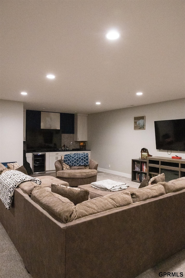 living area featuring baseboards, recessed lighting, and beverage cooler