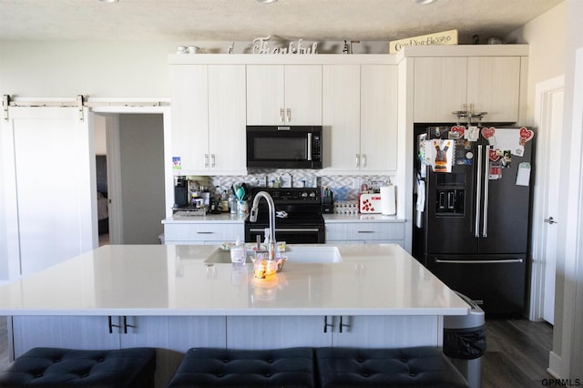 kitchen featuring a kitchen breakfast bar, stainless steel fridge with ice dispenser, and black range with electric stovetop