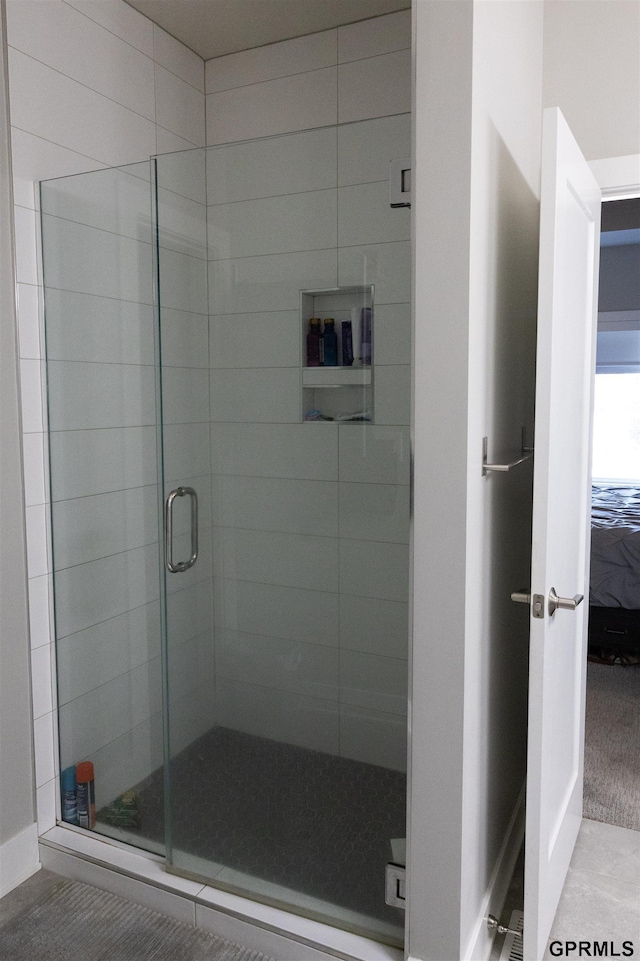 full bathroom featuring a stall shower and ensuite bathroom