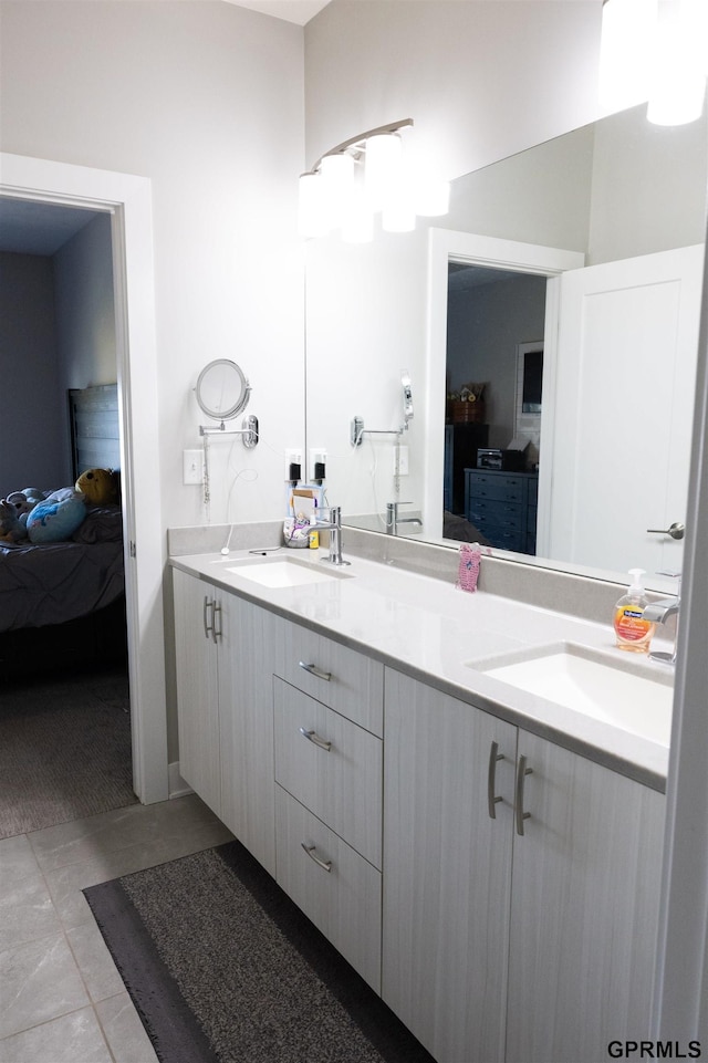 ensuite bathroom with a sink, double vanity, and connected bathroom