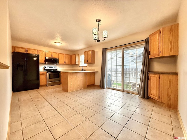kitchen featuring a sink, an inviting chandelier, light tile patterned floors, a peninsula, and appliances with stainless steel finishes