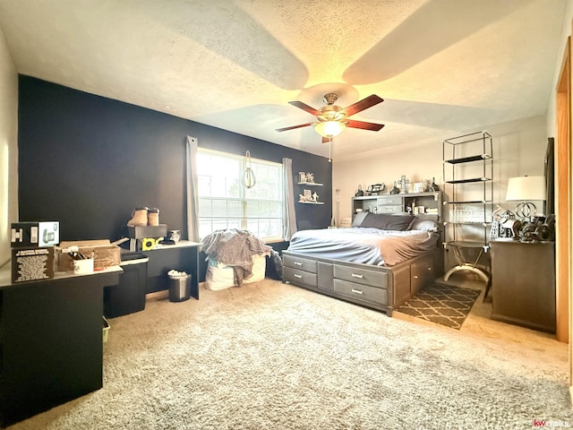 carpeted bedroom with a ceiling fan and a textured ceiling