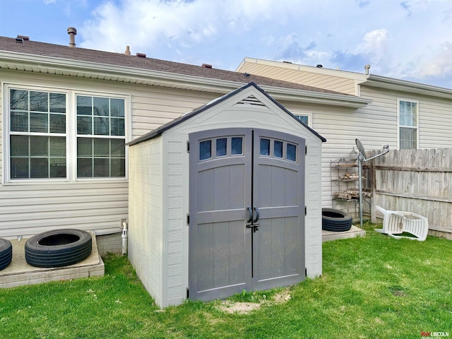 view of shed with fence