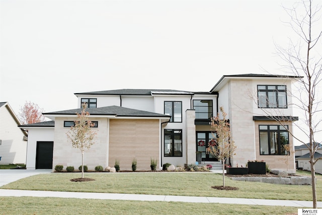 view of front of property with a front lawn, stone siding, stucco siding, an attached garage, and driveway