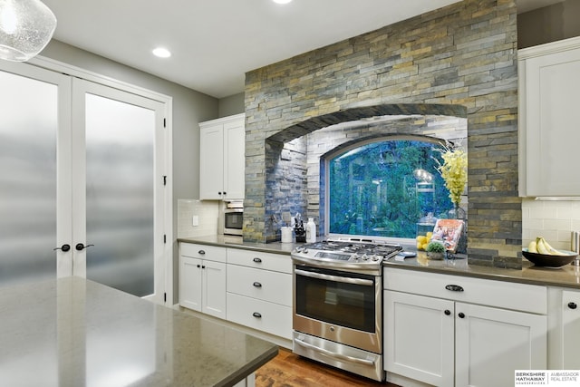 kitchen featuring recessed lighting, white cabinets, tasteful backsplash, and stainless steel appliances