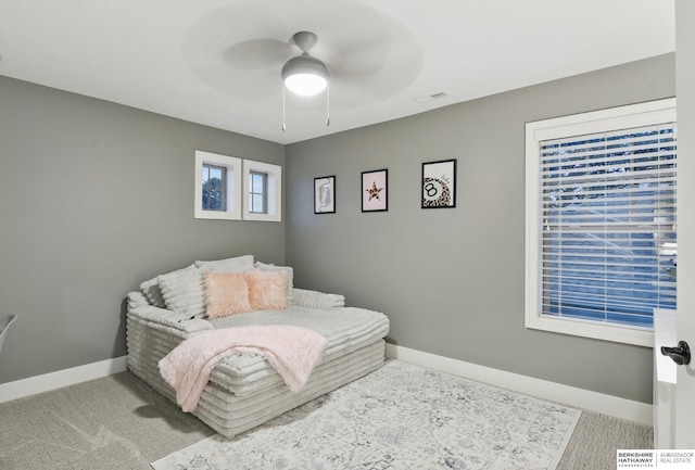 carpeted bedroom with a ceiling fan and baseboards