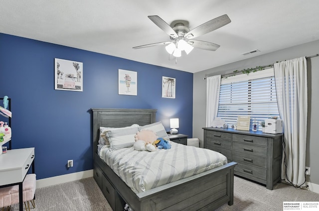 bedroom with light colored carpet, baseboards, visible vents, and ceiling fan