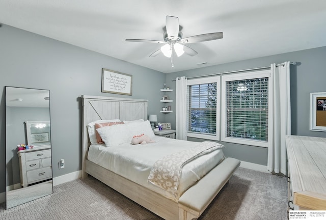 carpeted bedroom featuring baseboards and a ceiling fan