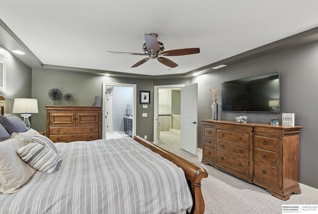 bedroom with baseboards, ceiling fan, light colored carpet, recessed lighting, and connected bathroom