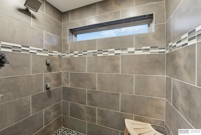 full bath with a tile shower