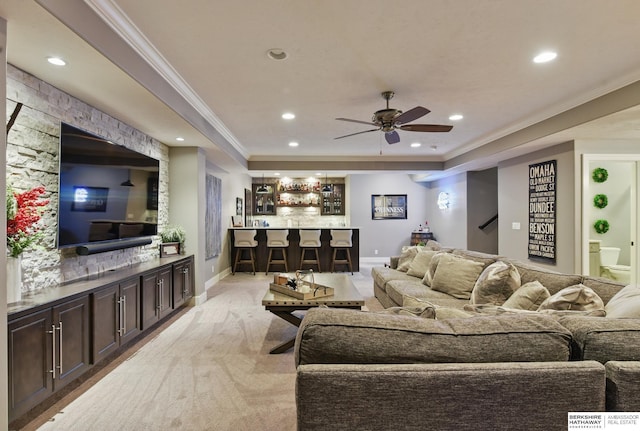 living room featuring ceiling fan, light carpet, recessed lighting, a tray ceiling, and ornamental molding