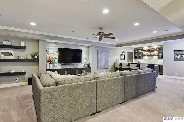 living room featuring light colored carpet, recessed lighting, wet bar, a ceiling fan, and ornamental molding