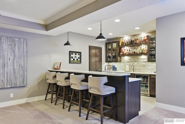 bar featuring backsplash, wet bar, beverage cooler, ornamental molding, and recessed lighting