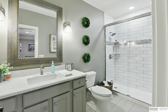 bathroom with vanity, tile patterned floors, a shower stall, and toilet