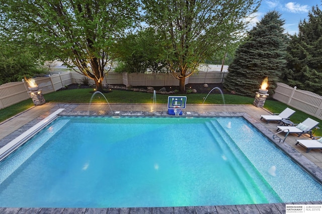 view of swimming pool featuring a lawn, a fenced in pool, and a fenced backyard