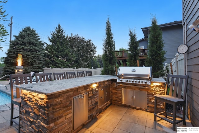 view of patio / terrace with fence, a pool, grilling area, and area for grilling
