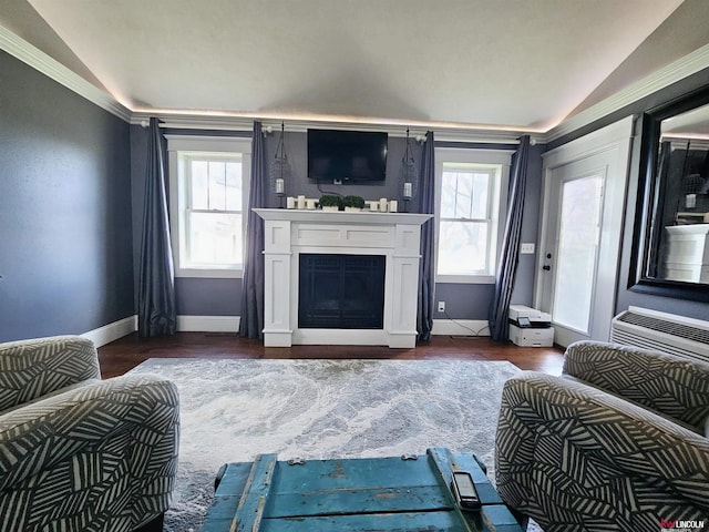 living area featuring baseboards, a healthy amount of sunlight, a fireplace, and lofted ceiling