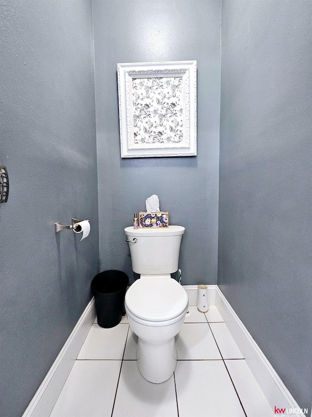 bathroom with toilet, tile patterned floors, and baseboards