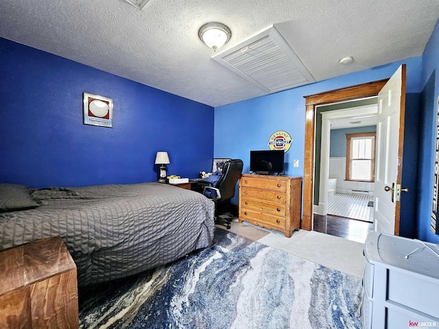 carpeted bedroom with a textured ceiling