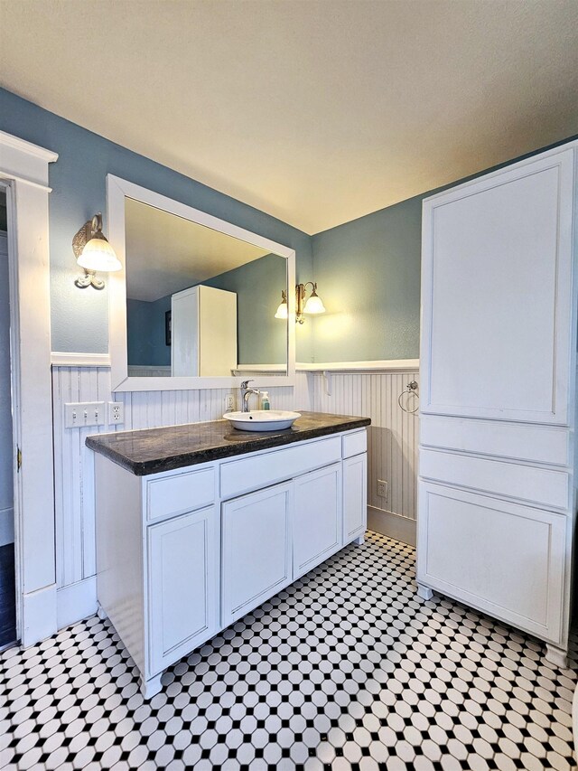 bathroom featuring vanity and a wainscoted wall