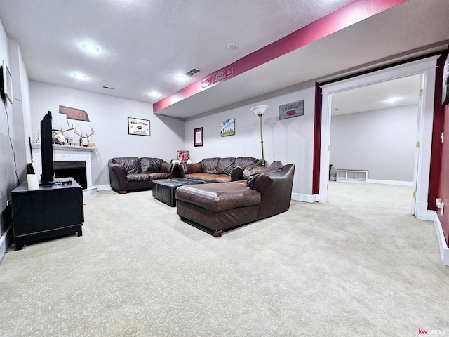 carpeted living room featuring baseboards, visible vents, and recessed lighting