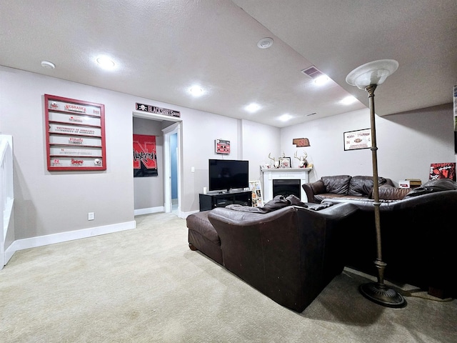 living room featuring a fireplace, baseboards, recessed lighting, and light carpet