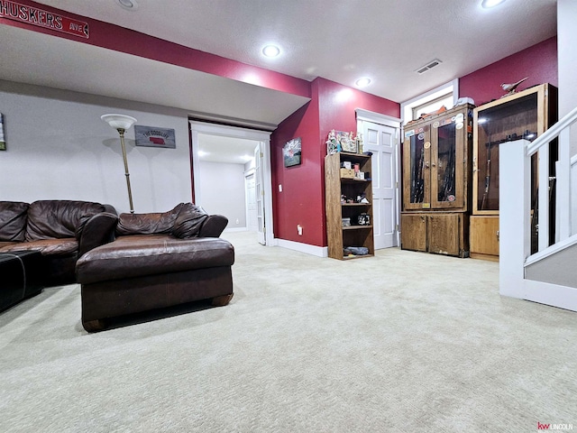 carpeted living room featuring recessed lighting, visible vents, and baseboards