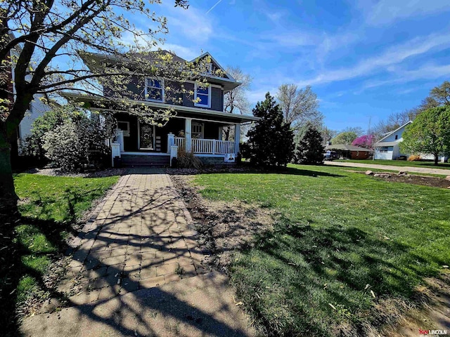 view of front of property with covered porch and a front lawn