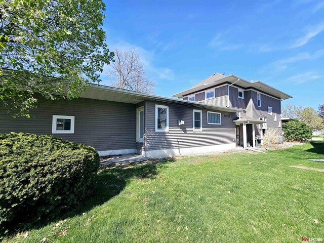 back of house with a yard and entry steps