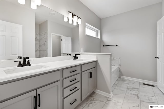 bathroom featuring baseboards, visible vents, marble finish floor, and a sink