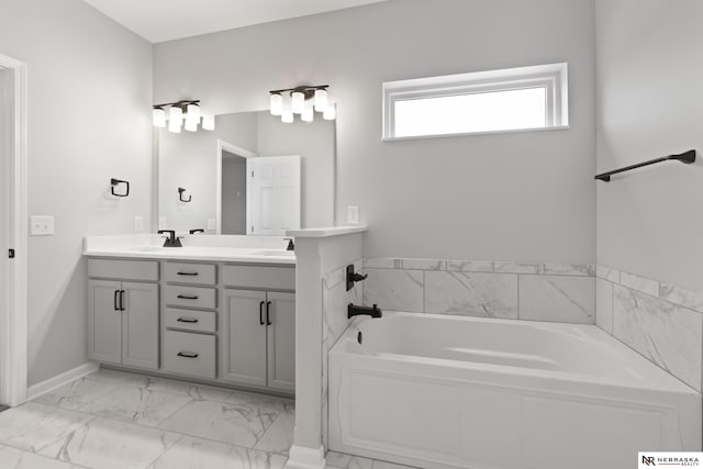 bathroom featuring double vanity, marble finish floor, a sink, baseboards, and a garden tub