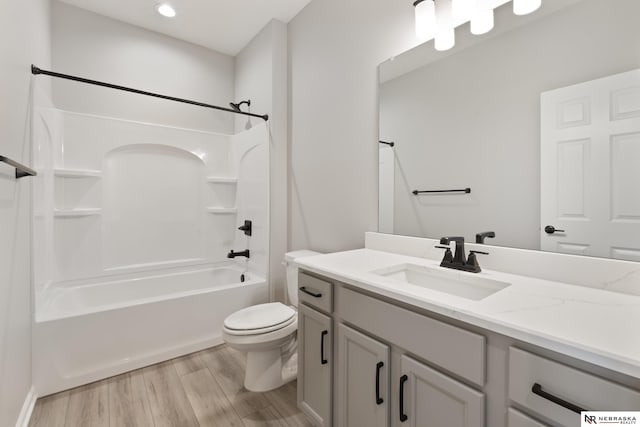 bathroom with recessed lighting, washtub / shower combination, vanity, toilet, and wood finished floors