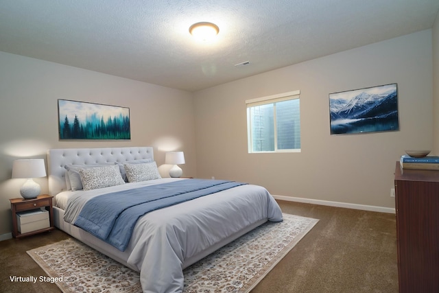 bedroom featuring baseboards, dark colored carpet, and visible vents