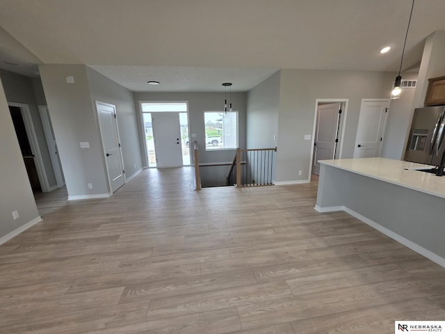 interior space with baseboards, recessed lighting, visible vents, and light wood-style flooring