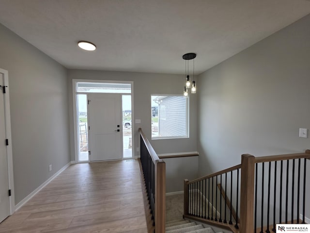 entryway with baseboards, light wood-style flooring, and plenty of natural light
