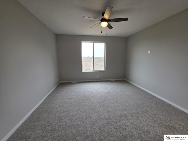 unfurnished room featuring a ceiling fan, carpet, and baseboards