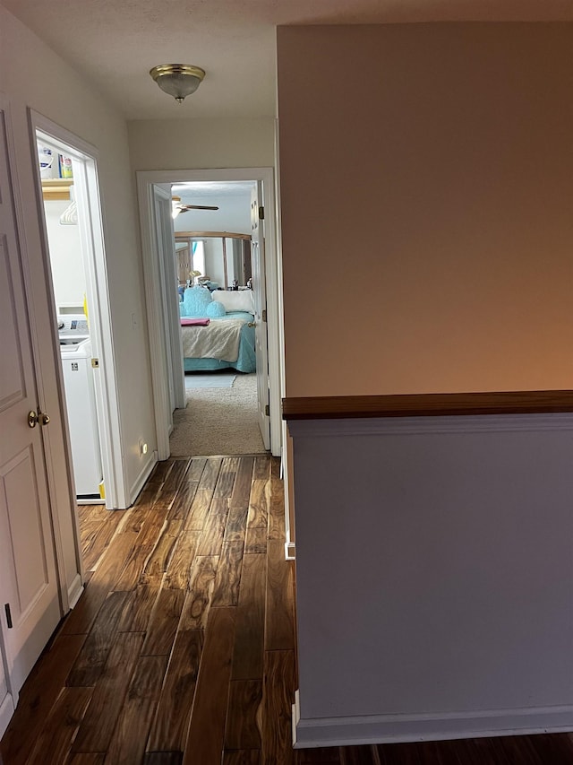 hallway featuring dark wood finished floors and washer / clothes dryer