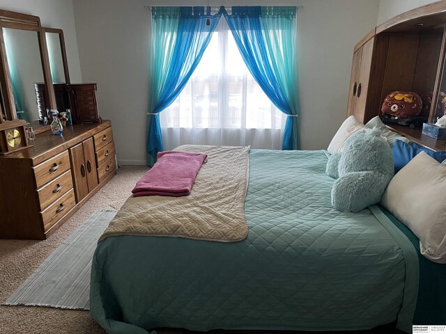 bedroom featuring light colored carpet