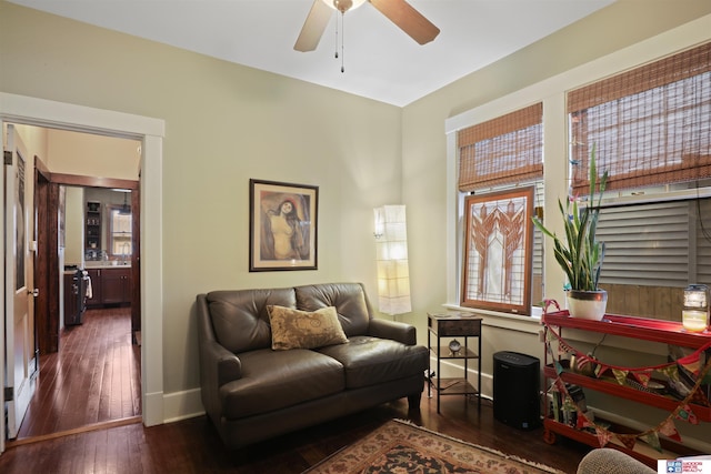 sitting room featuring baseboards, a ceiling fan, and hardwood / wood-style flooring