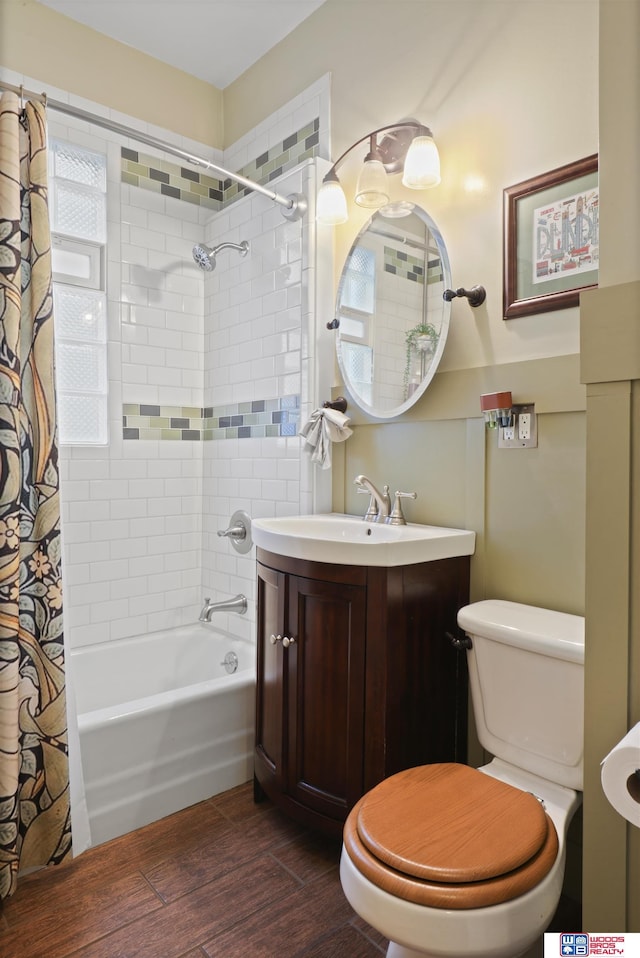bathroom with toilet, shower / bathtub combination with curtain, wood finished floors, and vanity