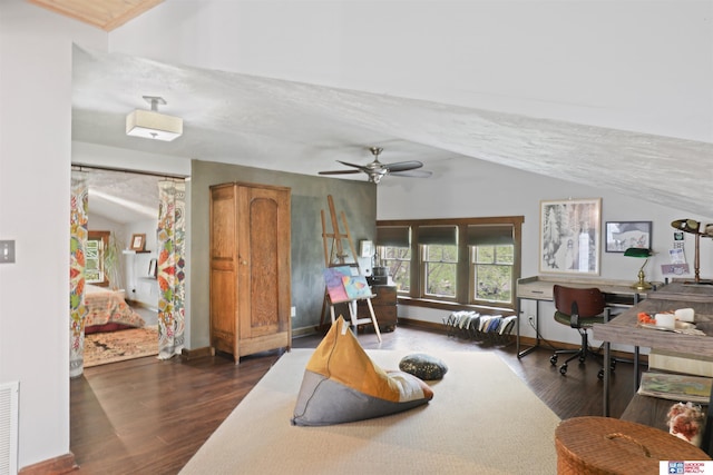 interior space with baseboards, ceiling fan, wood finished floors, and vaulted ceiling