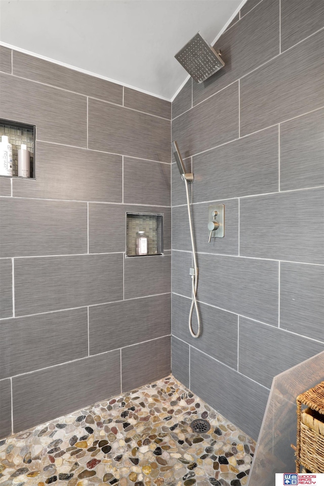 bathroom with tiled shower